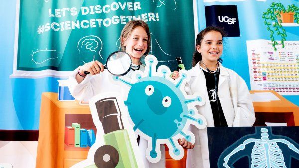 two girls take photos while dressed up in costumes