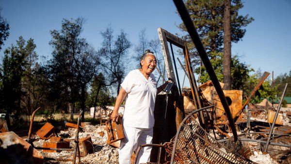 Woman standing in burned out lot