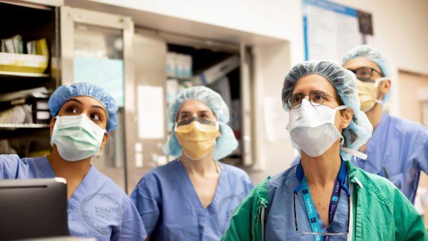 Surgeon and medical students in surgical scrubs