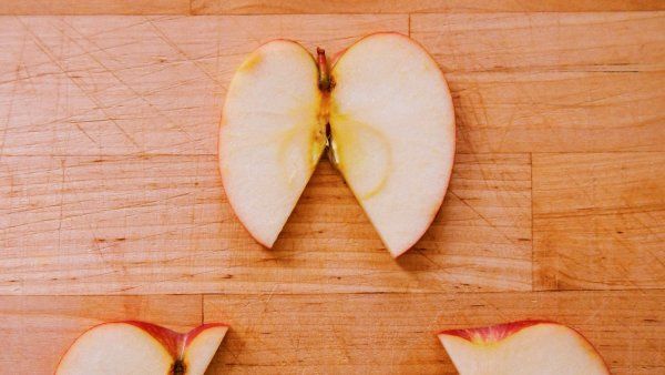 Three apple slices with pieces missing, suggesting a triangle