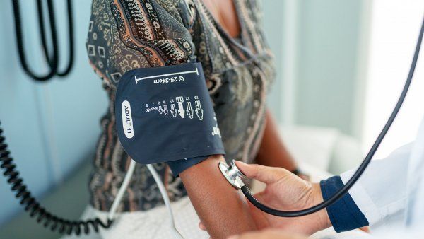 woman gets her blood pressure taken