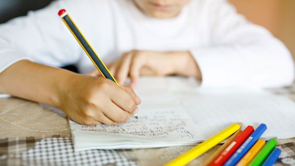 Child writing with pencil