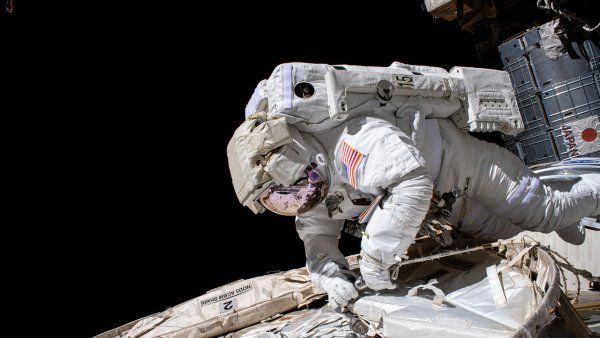 an astronaut on a spacewalk outside of a space station