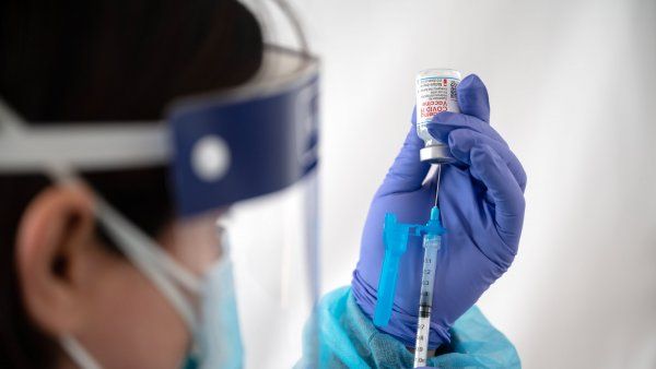 nurse prepares a COVID-19 vaccine shot