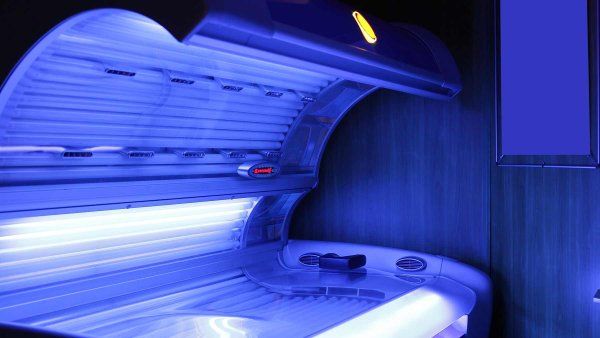 A tanning bed emitting a soft blue glow.