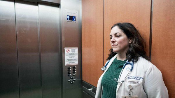 Larissa Thomas, a medical doctor, rides an elevator at Zuckerberg San Francisco General Hospital.