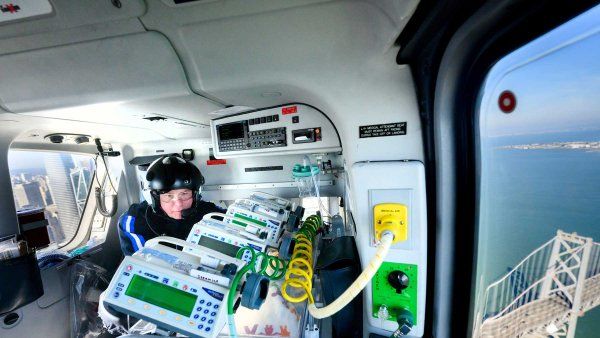 UCSF flight nurse tends to an incubator aboard a medical helicopter.