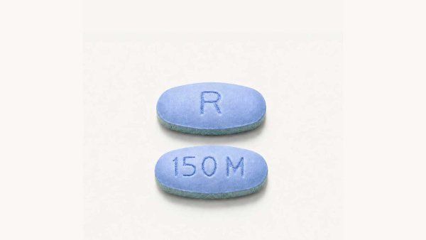 Two daraxonrasib pills, which are blue and oval in shape.