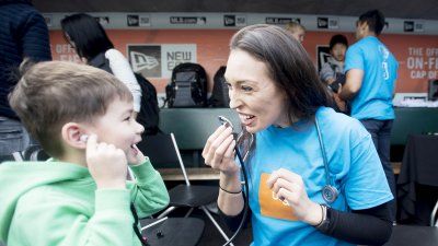 Misty Montoya teaches a child about stethoscopes at one of UCSF’s hands-on learning exhibit
