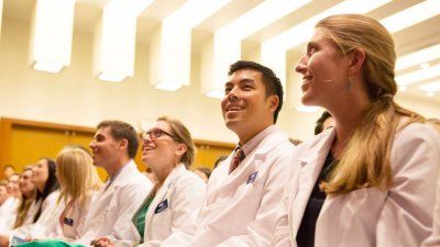 students seating at the white coat ceremony