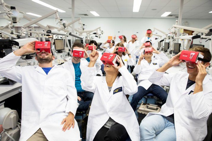 dentistry students looking at virtual reality headsets