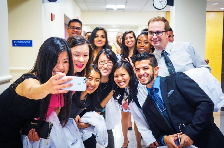 A group of pharmacy students pose for a selfie after their White Coat Ceremony