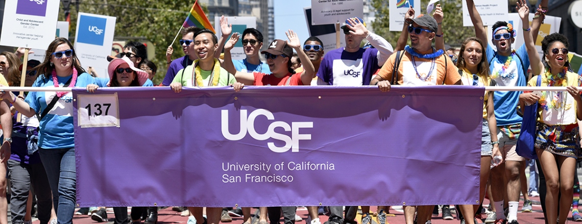 UCSF' contingent in the SF Pride Parade carries a UCSF banner down Market Street during the parade.