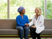 UCSF doctor sits with her patient in the hospital lobby