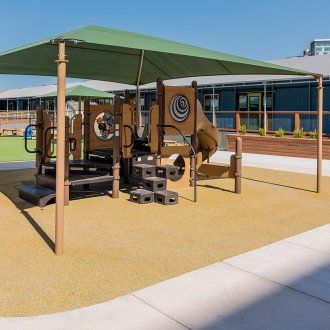 A jungle gym under a shaded canopy