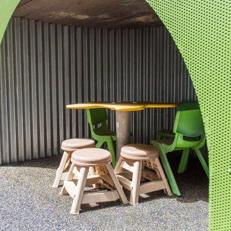 A small table and chairs within a cubby in a wall
