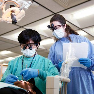 School of Dentistry student, Melanie Maddox, observes Narihide Kanayama, DMD at the UCSF Dental Center