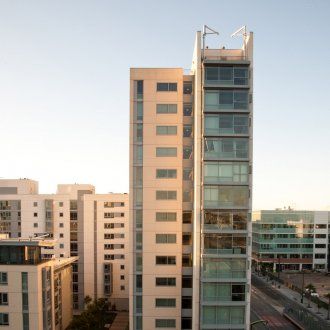 A long housing tower rising above the site with a wall of windows