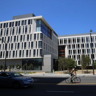 Mission Hall facade with a bicyclist riding by