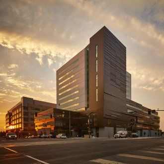 Bright clouds drift behind the building during sunset