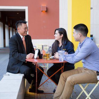 Some diners enjoy the open air at a patio table at The Pub