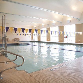 A broader view of the indoor pool showing ribbons of flags above the water