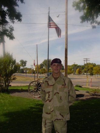 Aaron jackson in military uniform posing in front American flag