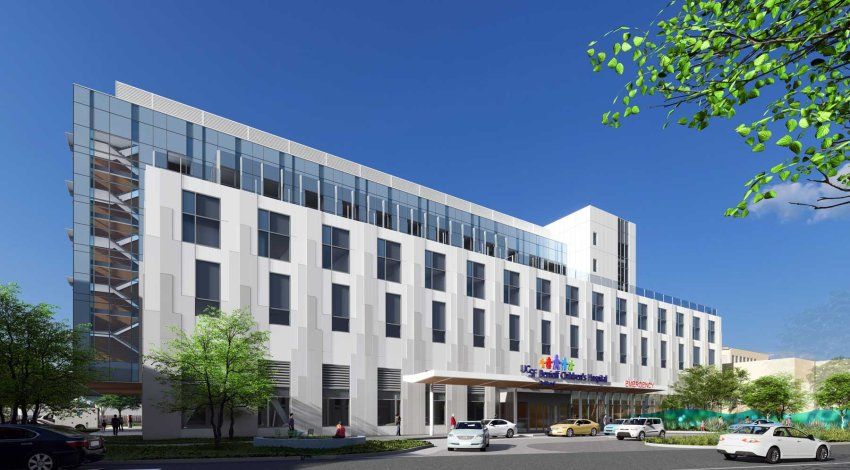 A rendered image of the new hospital building at UCSF Benioff Children's Hospital Oakland. The building is a rectangular, glassy building with seven stories.