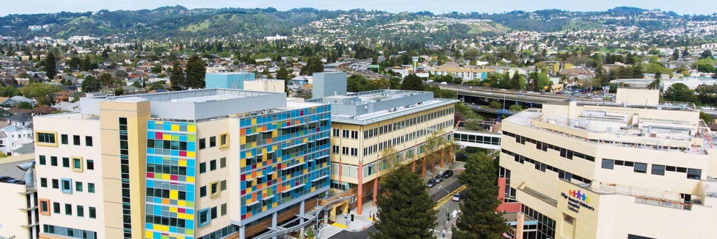 A bird's eye view of the U C S F Oakland campus, with the city of Oakland in the background.