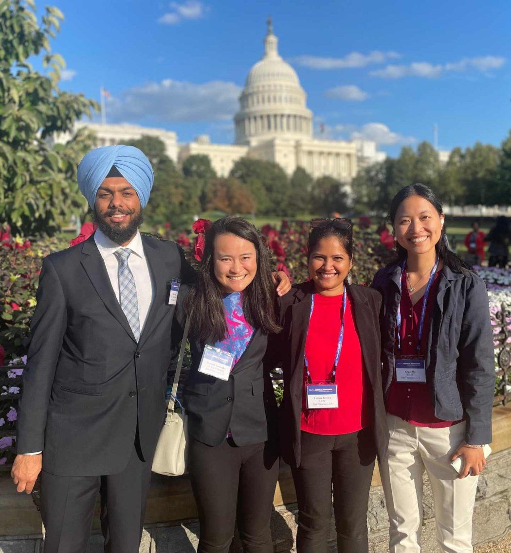 students smile posing in front of the white house capitol on a sunny day