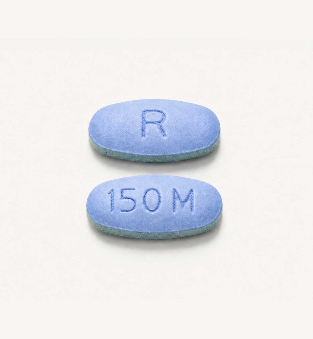 Two daraxonrasib pills, which are blue and oval in shape.