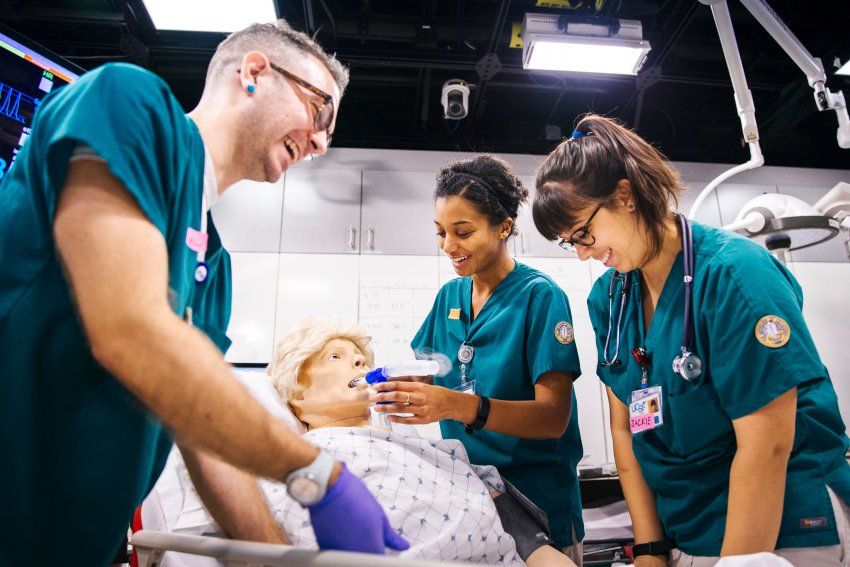 2 nursing students working on a dummy patient