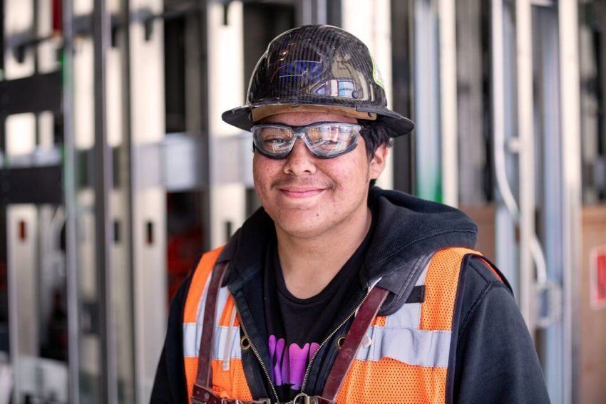 Young smiling worker wearing a hard hat