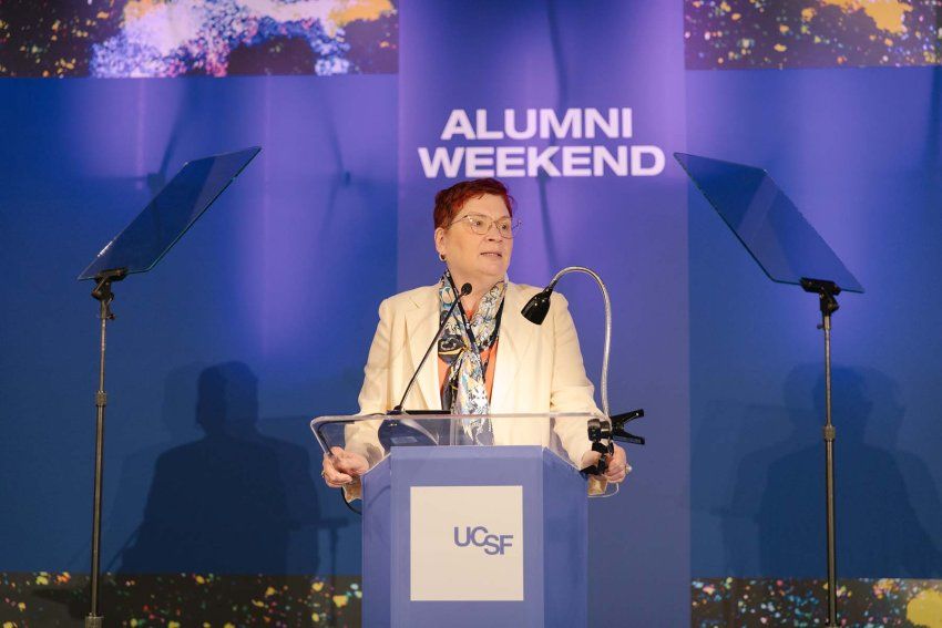 Catherine Lucey addresses the crowd from a podium during the 2023 Alumni Awards