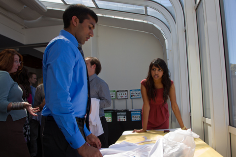 Anoop Muniyappa, left, with Alamelu Nates, both students in the UC Berkeley-UCSF joint medical program, adjusts his first white coat and name tag before the Sept. 7 White Coat Ceremony at UCSF.