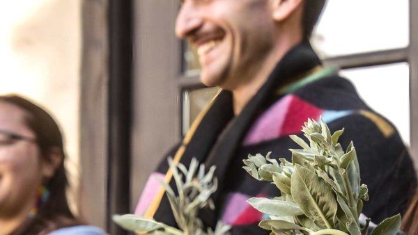 smiling graduate holds herbal bouquet 